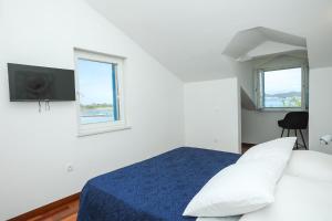 Postel nebo postele na pokoji v ubytování Apartments Seafront