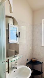 a bathroom with a sink and a mirror at Dubrovnik Apartments in Dubrovnik
