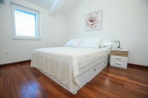 Postel nebo postele na pokoji v ubytování Apartments Seafront