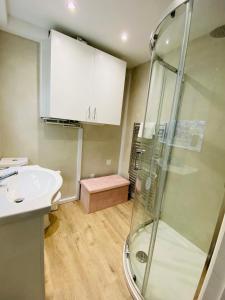 a bathroom with a sink and a shower at Green Sails House in Weymouth