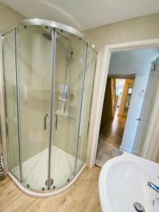 a bathroom with a shower and a sink at Green Sails House in Weymouth