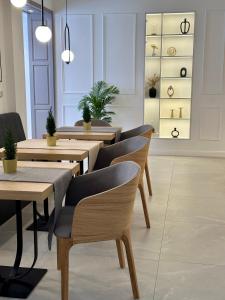 a restaurant with tables and chairs and potted plants at Hotel Antoni in Tomaszów Lubelski