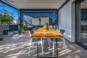 a wooden table and chairs on a patio at Premium Apartments in Vantačići