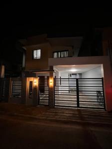 a house with a large garage door at night at Modern Home and Stylish Design in Ibaba