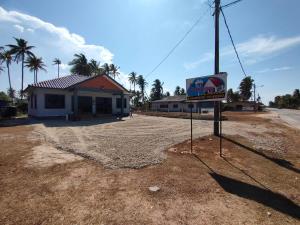 a motel with a sign in front of a building at Tok Mek Homestay in Setiu +6 photos