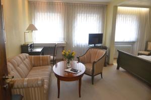 a living room with a couch and a table at Hotel Graupner in Bamberg