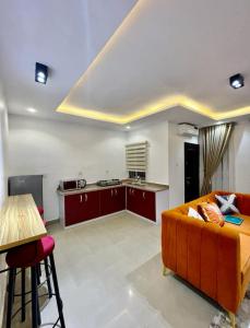 a living room with a couch and a kitchen at AL_MUBARAK ,APARTMENT in Ikeja