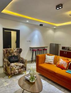 a living room with a couch and a table at AL_MUBARAK ,APARTMENT in Ikeja
