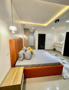 a bedroom with a bed and a bench in it at AL_MUBARAK ,APARTMENT in Ikeja