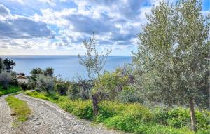 a dirt road next to the ocean on a cloudy day at Awesome Apartment In Recco With Kitchen in Recco