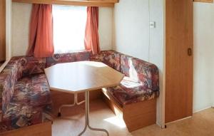 a living room with a couch and a table at 2 Bedroom Amazing Home In Mielno in Mielno