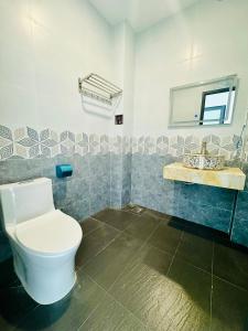 a bathroom with a toilet and a sink at Lava Rock Viet Nam Lodge in Cat Tien