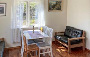 a living room with a table and a leather chair at Amazing Home In Engesland With House A Panoramic View in Evje