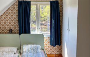 ein Schlafzimmer mit blauen Vorhängen und einem Fenster in der Unterkunft Amazing Home In Engesland With House A Panoramic View in Evje