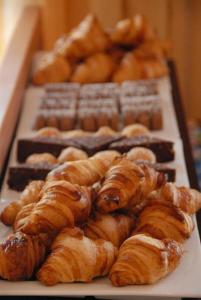a bunch of croissants and other pastries on a table at PFA Hotel Viareggio in Viareggio