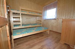 a room with bunk beds and a window at Domki letniskowe Darłowo in Darłowo