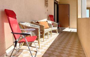 a room with chairs and a table and a room with a table at Pet Friendly Apartment In Marzamemi in Marzamemi