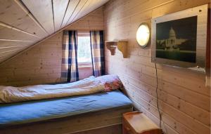 a small room with a bed in a log cabin at Gorgeous Home In Vikedal With Kitchen in Vikedal