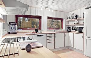 a kitchen with white cabinets and a counter top at Lovely Home In Bording With Wifi in Bording Stationsby