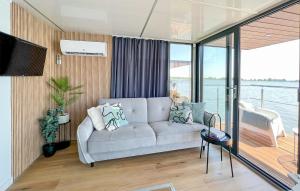 a living room with a couch and a balcony at Cozy Ship In Mielno With Kitchen in Mielno