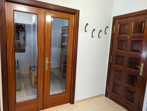 a wooden door in front of a white wall at Don Manuel Cuntis in Cuntis