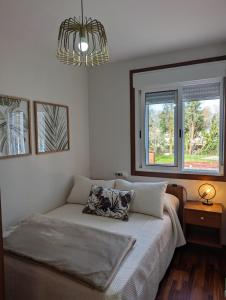 a bedroom with a bed with two pillows on it at Don Manuel Cuntis in Cuntis