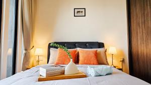 a bedroom with a bed with a vase and books at [InfinityPool][9px] Beacon Executive Suites in George Town