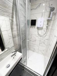 a bathroom with a shower and a sink at Letzi Private En-Suite In Harrow in Pinner