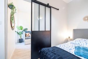 a bedroom with a black door and a bed at Le GRAND JEAN in Nice