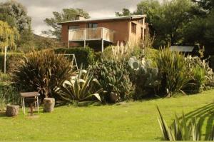 a house with a bunch of plants in the yard at Altitud 410 in Villa Ventana