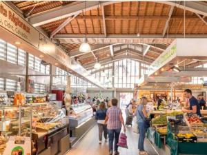 a group of people walking through a produce market at La Perle de Houlgate Élégance & Vue 4 pers in Houlgate