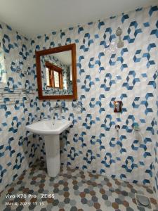 a bathroom with a sink and a mirror at Royal galaxy in Pahalgām