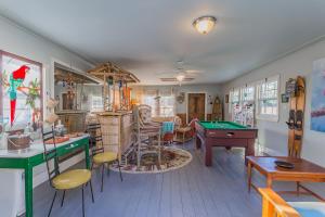 a living room with a pool table in it at Creekside Paradise in Tybee Island