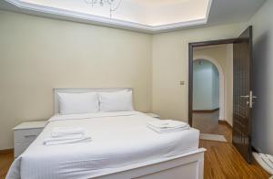a bedroom with a large white bed with two towels on it at ZAPBED House - AWP 1501 in Dubai