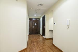 a hallway of an office with a door and wood floors at ZAPBED House - AWP 1501 in Dubai