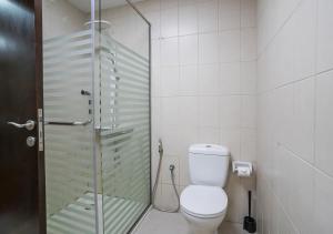 a bathroom with a toilet and a glass shower at ZAPBED House - AWP 1501 in Dubai