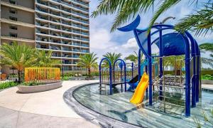 a playground in a pool with a slide at The Song Luxury Vung Tau Apartment - QUỲNH's Homestay in Vung Tau