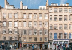 a large brick building on a city street at High Street Apartment in Edinburgh