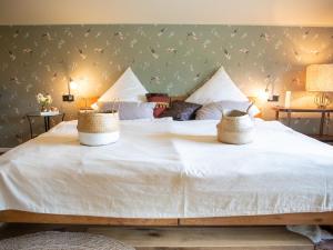 a large white bed with two baskets on it at Chalet Alte Schmiede in Göstling an der Ybbs
