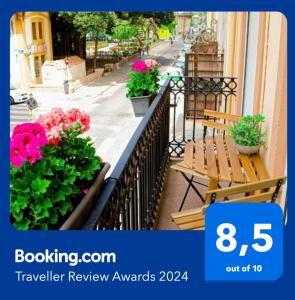 a balcony with flowers and a bench on a street at Your home in Valencia in Valencia