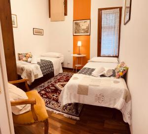 a room with two beds and a window at Grimaldi Apartments Cannaregio in Venice