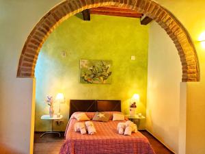 a bedroom with a bed with two stuffed animals on it at Guest-House Del Corso in Montepulciano +14 photos