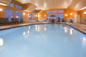 a large swimming pool in a hotel room at GrandStay Hotel & Suites - Morris in Morris