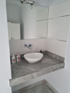 a bathroom with a white sink and a mirror at Tu descanso en Coronel Suarez in Coronel Suárez