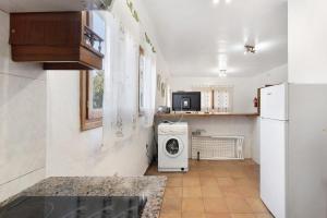 a kitchen with a washing machine and a refrigerator at Casa Epina in Vallehermoso +15 photos