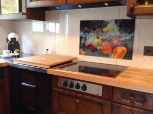 a kitchen with a sink and a painting on the wall at Appartement Arve in Saas-Almagell