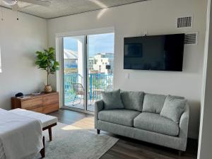 a living room with a couch and a flat screen tv at Mint House St. Petersburg - Downtown in St. Petersburg