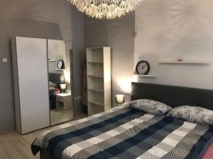 een slaapkamer met een bed en een klok aan de muur bij River City Apartments in Rijeka