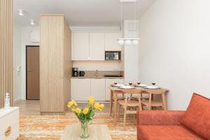 a living room with a couch and a table at Bel Mare Modern Apartment with Balcony by Renters in Międzyzdroje