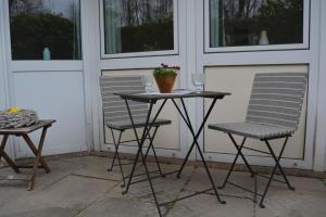 two chairs and a table with a plant on a porch at Kiek mol in in Ottensen